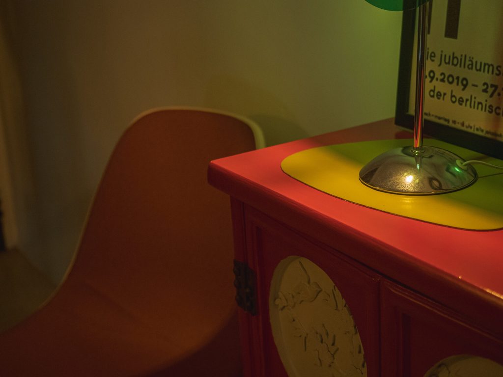 Vintage colorful furniture detail with red cabinet and retro lamp