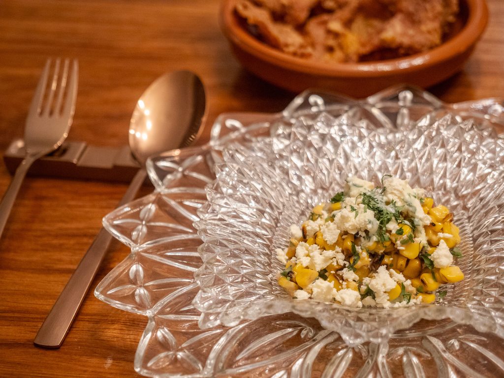 Corn salad dish served in vintage crystal bowl at 61 Orange